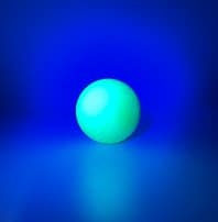 neon yellow golf ball under UV light