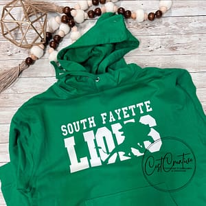 Kelly green hooded sweatshirt with white text. South Fayette over LIONS. Image of a lion is knocked out of the word lion for an artistic effect.