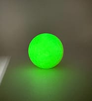 neon yellow golf ball regular light after UV charge