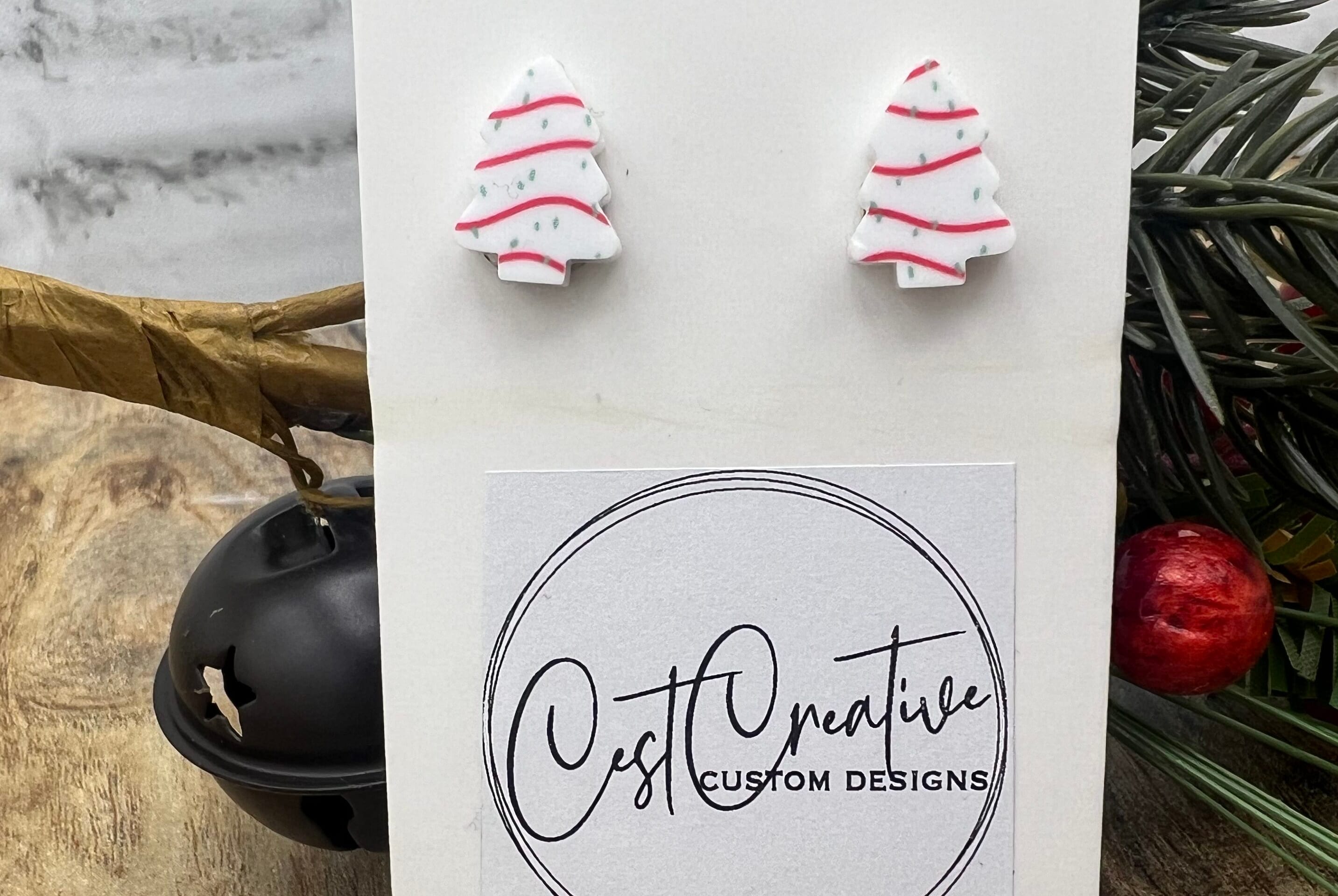white Christmas tree earrings with red stripes and green dots